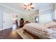 Spacious bedroom with hardwood floors, ceiling fan, and access to other rooms at 203 Brick St, Wake Forest, NC 27587