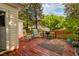 Outdoor deck for relaxation with grill, rocking chairs, wooden railings, and lush greenery at 203 Brick St, Wake Forest, NC 27587