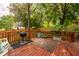 Outdoor deck perfect for entertaining with grill, wooden railings, and lush greenery at 203 Brick St, Wake Forest, NC 27587