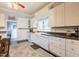 Bright eat-in kitchen features white cabinetry, modern appliances, and natural light at 203 Brick St, Wake Forest, NC 27587