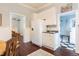 Eat-in kitchen features white cabinets, stainless refrigerator, and a view into other rooms at 203 Brick St, Wake Forest, NC 27587