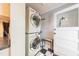 Efficient laundry room featuring a stacked washer and dryer and durable flooring at 203 Brick St, Wake Forest, NC 27587
