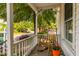 Relaxing front porch with rocking chair and potted plants at 203 Brick St, Wake Forest, NC 27587