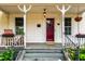 Cozy front porch with rocking chair, flower boxes, and vintage lighting at 203 Brick St, Wake Forest, NC 27587