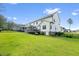 Expansive green backyard with screened porch and the exterior of a well-maintained two-story white home at 211 Education Dr, Spring Lake, NC 28390