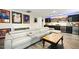 Finished basement with a large gray sectional sofa, wet bar, and beverage fridge at 211 Education Dr, Spring Lake, NC 28390