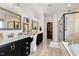 Luxurious bathroom featuring double vanities, granite countertops, and a walk-in shower and a soaking tub at 211 Education Dr, Spring Lake, NC 28390