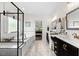 Well lit bathroom with marble floors, a soaking tub, double vanities, and large mirrors at 211 Education Dr, Spring Lake, NC 28390