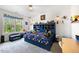 A bedroom with a well decorated bed, dresser and window overlooking a wooded area at 211 Education Dr, Spring Lake, NC 28390