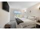 Bright bedroom with a large window, plush carpet, neutral decor, and a mounted TV at 211 Education Dr, Spring Lake, NC 28390