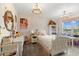 A bedroom with a well decorated bed, lighting and dresser at 211 Education Dr, Spring Lake, NC 28390