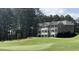 The lawn leads up to multi-story homes, nestled against a backdrop of tall trees at 211 Education Dr, Spring Lake, NC 28390