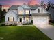 Charming two-story home with a manicured lawn, inviting front porch, and a two car garage at 211 Education Dr, Spring Lake, NC 28390