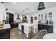 Well-equipped kitchen with island seating, sleek black and white cabinetry, and modern lighting at 211 Education Dr, Spring Lake, NC 28390