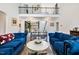 Spacious living room with high ceilings, two blue sofas and open layout to the dining area at 211 Education Dr, Spring Lake, NC 28390