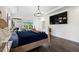 A beautifully decorated main bedroom featuring a large television, ensuite sitting room, and hardwood floors at 211 Education Dr, Spring Lake, NC 28390