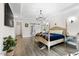 Spacious main bedroom with tray ceilings, hardwood floors, ensuite bathroom, and barn door at 211 Education Dr, Spring Lake, NC 28390
