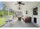 Relaxing screened porch featuring a seating area, ceiling fans, and a comfortable hammock at 211 Education Dr, Spring Lake, NC 28390