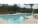 Community swimming pool offers lanes for exercise and lounge chairs for relaxation at 211 Education Dr, Spring Lake, NC 28390