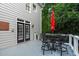 Back deck with outdoor seating and dark framed double doors to the home at 2112 Tulare Ct, Raleigh, NC 27612