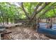 Secluded backyard oasis with lush greenery, stone path, and charming swing at 2112 Tulare Ct, Raleigh, NC 27612