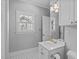 Light-filled bathroom features a classic sink and vanity with a bright window at 2112 Tulare Ct, Raleigh, NC 27612