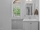 Clean bathroom with window shutters, vanity and white cabinets at 2112 Tulare Ct, Raleigh, NC 27612