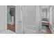 Bright bathroom features a tub and shower with white tile and access to the nearby living room at 2112 Tulare Ct, Raleigh, NC 27612