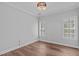 The empty bedroom features hardwood floors, a chandelier, and shuttered windows at 2112 Tulare Ct, Raleigh, NC 27612