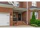 Inviting brick front porch with black door and matching black iron railings at 2112 Tulare Ct, Raleigh, NC 27612