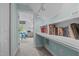 Hallway with built-in shelving, leading to a well-lit office space at 2112 Tulare Ct, Raleigh, NC 27612