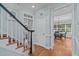 Inviting foyer features hardwood floors, staircase with white spindles and a view into the dining room at 2112 Tulare Ct, Raleigh, NC 27612