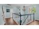 Hallway with chandelier and staircase to the lower level at 2112 Tulare Ct, Raleigh, NC 27612