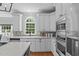 Modern kitchen with granite countertops, stainless steel appliances, white cabinetry and lots of natural light at 2112 Tulare Ct, Raleigh, NC 27612