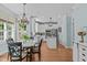 Open concept eat-in kitchen with an island, stainless steel appliances, and a chandelier over the dining table at 2112 Tulare Ct, Raleigh, NC 27612
