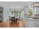 Bright eat-in kitchen features a chandelier over the dining table and large windows with exterior views at 2112 Tulare Ct, Raleigh, NC 27612