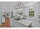 Open kitchen with granite countertops, white cabinetry, stainless appliances, and access to the living room and dining area at 2112 Tulare Ct, Raleigh, NC 27612