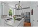 Modern kitchen features stainless steel appliances, granite countertops and an island with cooktop at 2112 Tulare Ct, Raleigh, NC 27612