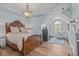 The primary bedroom features a wooden bed frame, hardwood floors, and a sunny window seat at 2112 Tulare Ct, Raleigh, NC 27612
