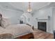 This bedroom features an elegant bed, fireplace, and dormer window at 2112 Tulare Ct, Raleigh, NC 27612