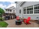 Backyard patio with an outdoor cooking area and red Adirondack chairs at 2112 Tulare Ct, Raleigh, NC 27612