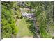 Aerial view of the home showcasing its expansive lawn and wooded surroundings at 216 Brook Ln, Durham, NC 27712