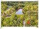 Aerial view of the property with trees and a large lake nearby at 216 Brook Ln, Durham, NC 27712