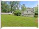 Expansive backyard featuring mature trees and lush green grass at 216 Brook Ln, Durham, NC 27712