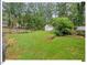 Large backyard with mature trees and a garden plot with a shed at 216 Brook Ln, Durham, NC 27712
