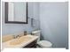 Powder room featuring a vanity and toilet with a mirror and towel rack at 216 Brook Ln, Durham, NC 27712