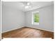 Bright bedroom features hardwood floors, ceiling fan, and a window with a view at 216 Brook Ln, Durham, NC 27712