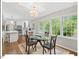 Open concept dining with new lighting, next to the kitchen with an island, and large windows at 216 Brook Ln, Durham, NC 27712