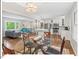 Bright and open floor plan featuring a glass dining table, hardwood floors, and a modern kitchen at 216 Brook Ln, Durham, NC 27712