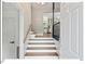 Bright entryway with hardwood stairs and a view into the open-concept kitchen and living area at 216 Brook Ln, Durham, NC 27712